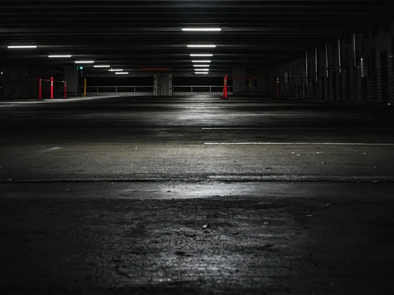 A lit but empty multi-storey car park at night.