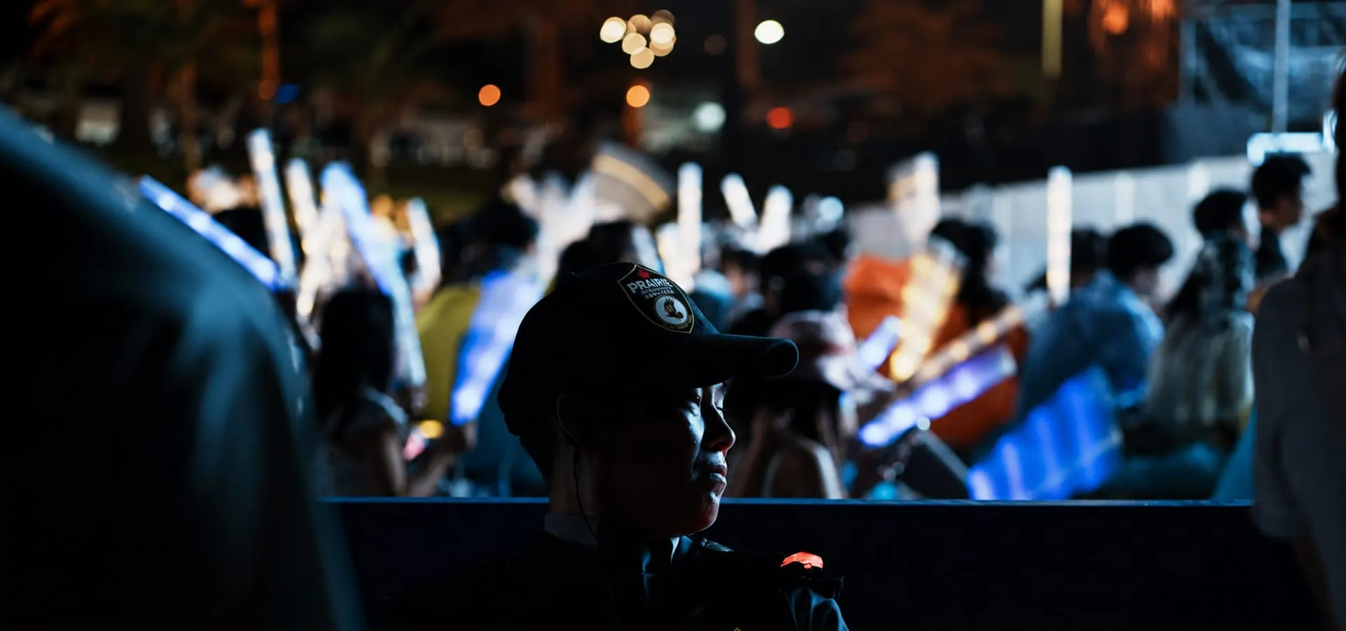 A Prairie Integrated Services officer on duty at a night-time public event.